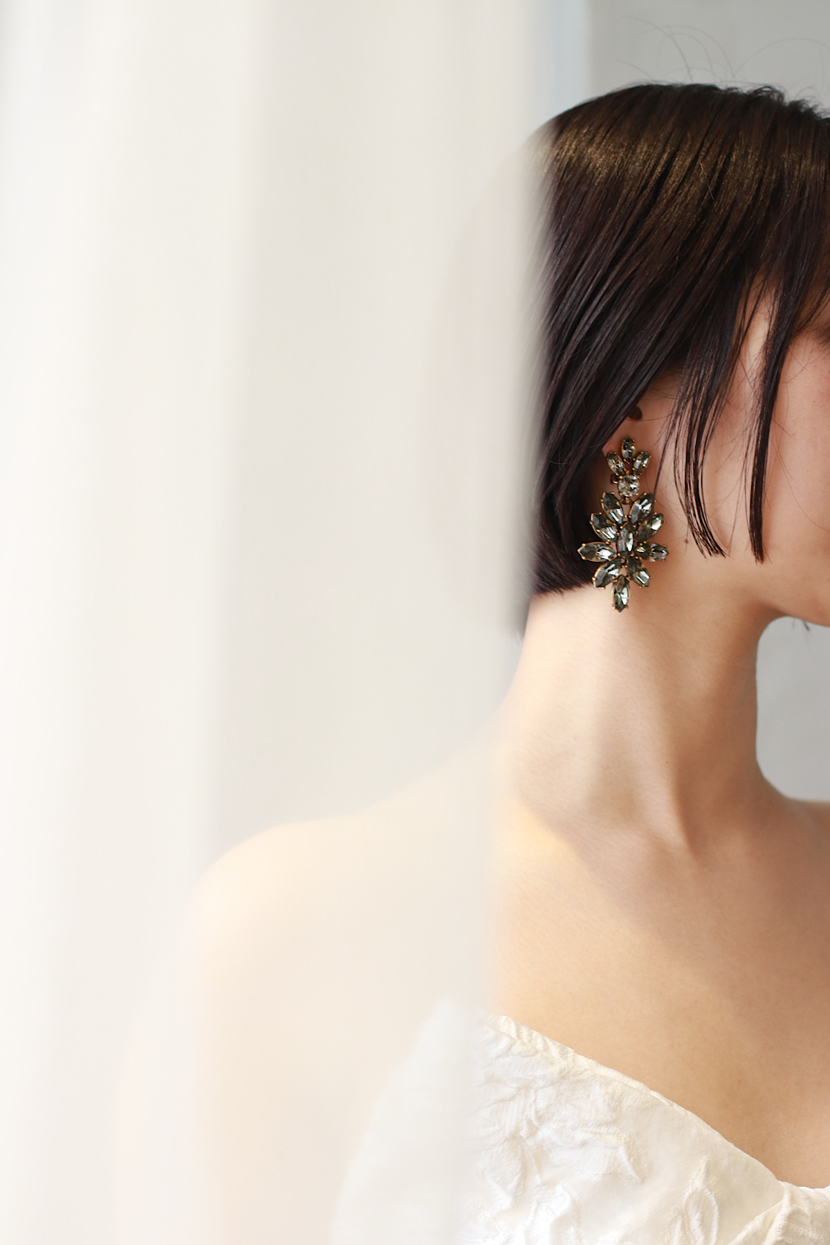 トリートドレッシングでお取り扱いしているオスカーデラレンタのブラックストーンのイヤリングが胸元のアイキャッチーなウエディングドレスにアクセントになるファッショナブルなコーディネート