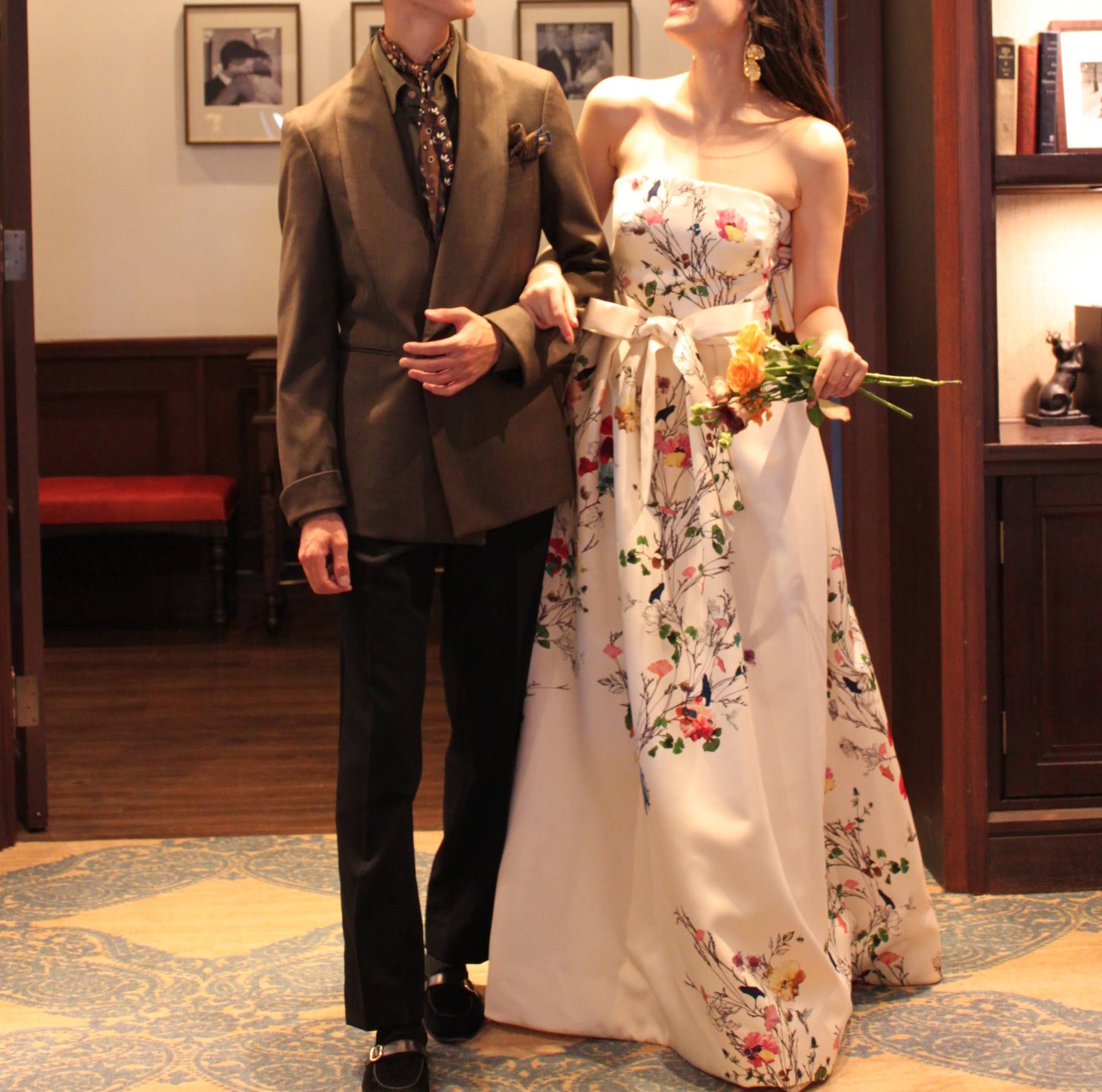 新郎様はブラウンの色味を使ったコーディネートで新婦様の白地にプリント柄のカラードレスを引き立たせます