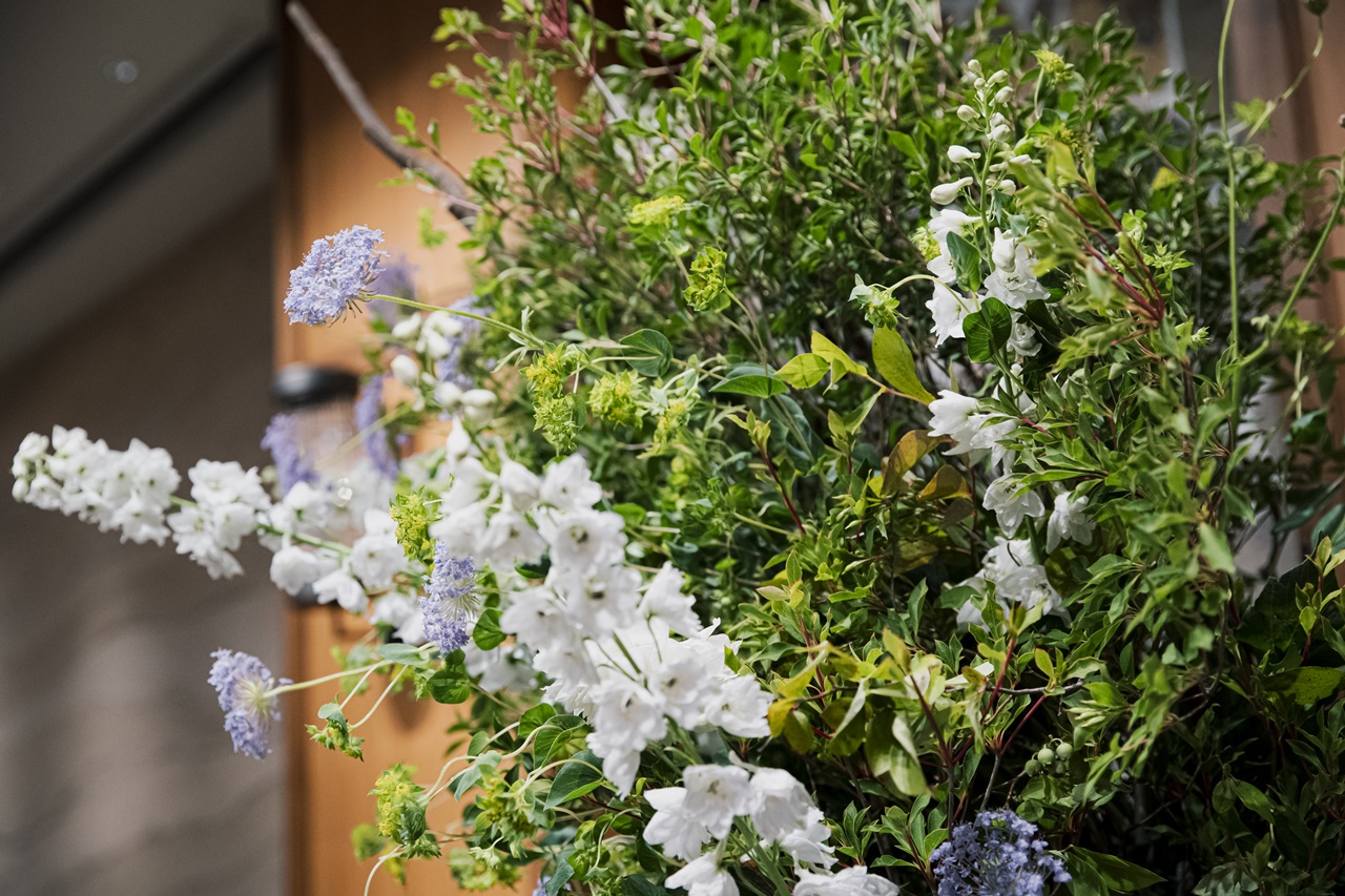 シックな会場と鮮やかな衣装を引き立てる装花はグリーンとホワイトを基調としたシンプルな色味でまとめられました