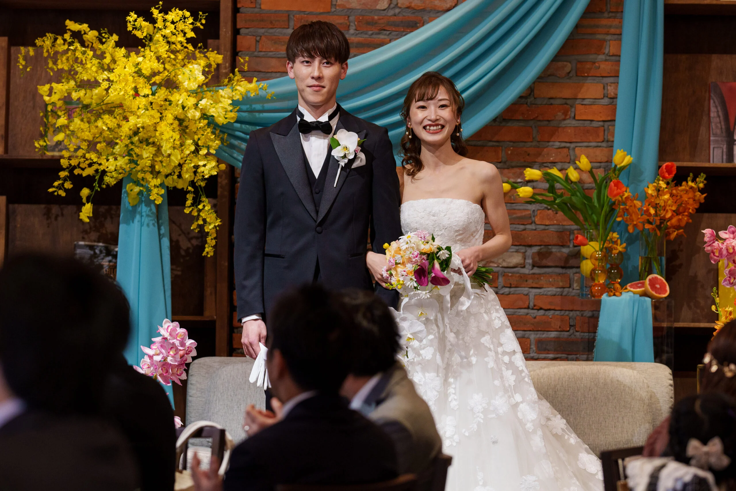 ザ ルイガンズのザ グランドガーデンでの結婚式は木目調の館内に装花が映えお二人らしい雰囲気を楽しんでいただけます